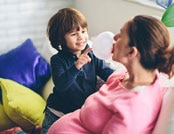 boy popping mom’s gum bubble